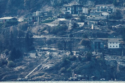 Destroyed houses are seen from across Lake Okanagan almost a week after the McDougall Creek burned through the community of West Kelowna, British Columbia, Canada August 24, 2023.