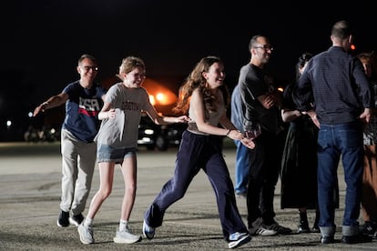 Las hijas de la periodista Alsu Kurmasheva, Bibi y Miriam Butorin, y su esposo, Pavel Butorin, corren a encontrarse con ella, a su llegada a la base aérea de Andrews, en el estado de Maryland (EE UU).