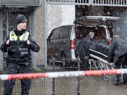 Corpses are carried out of a Jehovah's Witness building and loaded into hearses in Hamburg, Germany, on March 10, 2023.