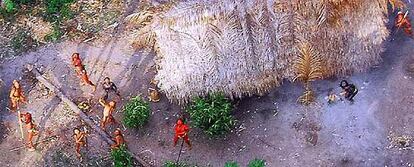 Miembros de la nueva tribu descubierta en Brasil apuntan al aire con sus arcos desde donde se les está fotografiando