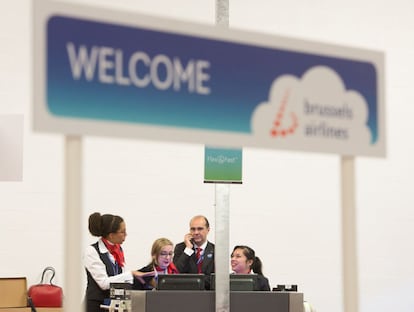 Empleados de la compañía Brussels airline esperan en la zona de facturación.