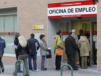 People stand in line outside a Madrid employment office.