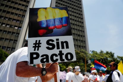 Vestidos en su mayoría con camisetas blancas, los manifestantes se concentraron en diferentes puntos neurálgicos de ciudades como Bogotá, Cali, Medellín, Cartagena, Bucaramanga y Barranquilla. En la imagen, un hombre sostiene un cartel en una protesta contra el Gobierno del presidente de Petro, en Cali.
