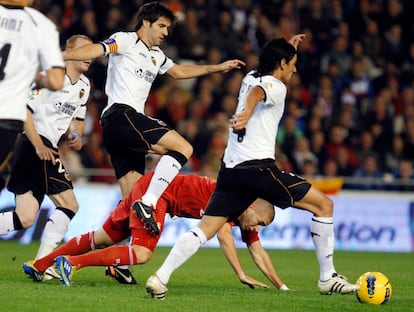 Albelda intenta esquivar a Benzema mientras Tino Costa se lleva el balón.