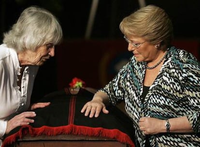 La presidenta chilena, Michelle Bachelet, y la británica Joan Turner (i), viuda del cantautor chileno Víctor Jara ante su féretro