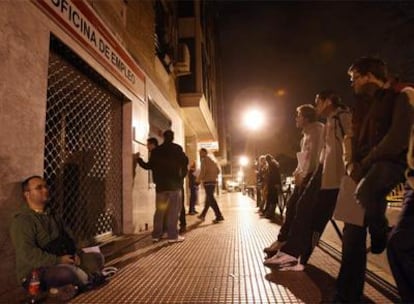 Un grupo de parados hace cola de madrugada en la oficina de empleo de la localidad madrileña de Torrejón de Ardoz.