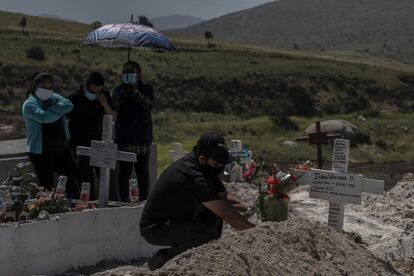 Los trabajadores del cementerio permiten el paso de los familiares de la víctima para poder dejar sus ofrendas florales únicamente después de que el ataúd quede bajo tierra.