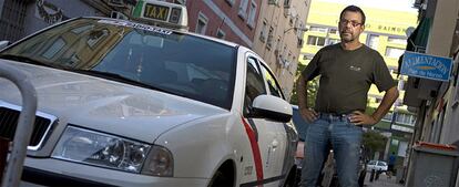 Antonio Berbel posa con su taxi en una calle del distrito madrileño de Puente de Vallecas.