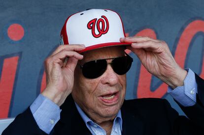 In this Feb. 28, 2017, file photo, Washington Nationals owner Ted Lerner tries on a baseball cap before a ribbon cutting ceremony to open The Ballpark in West Palm Beach, Fla.