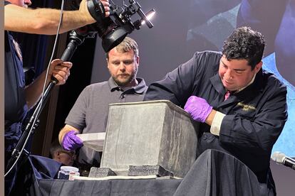 Paul Hudson, left, West Point archeologist, and Michael Diaz, West Point Museum curator, take part in the opening of a lead box believed to have been placed in the base of a monument by cadets almost two centuries ago, at the U.S. Military Academy, Monday, Aug. 28, 2023, in West Point, N.Y. The box contained silt. (AP Photo/Michael Hill)