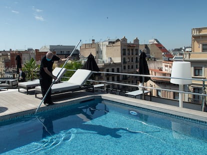 Un empleado realiza tareas de mantenimiento en la piscina de un hotel de Barcelona, este miércoles.