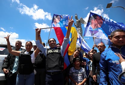 Ecuadorean presidential candidate Yaku Perez and his running mate Nory Pinela, both wearing bulletproof vests, hold hands, after a closing campaign rally, in Quito, Ecuador, on August 17, 2023.