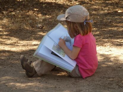 A natureza te permite conectar, mas também investigar e manter ativos os processos de curiosidade. Na imagem, uma menina observa atentamente um bicho que encontrou em um dia de escola no grupo de jogos do Naturaleza Saltamontes, em Madri.