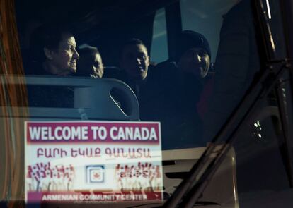 Syrian refugees leave a hotel aboard a bus to the Armenian Community Centre, which sponsors Syrian refugees that arrived Thursday, in Toronto, Friday, Dec. 11, 2015. (Nathan Denette/The Canadian Press via AP) MANDATORY CREDIT