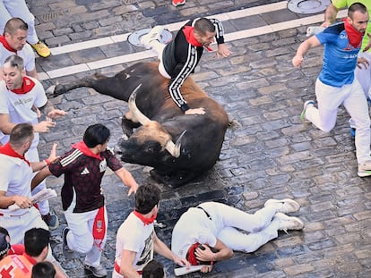 Un corredor salta por encima de uno de los toros de la ganadería Álvaro Núñez durante el tercer encierro de los Sanfermines 2025, este miércoles en Pamplona.