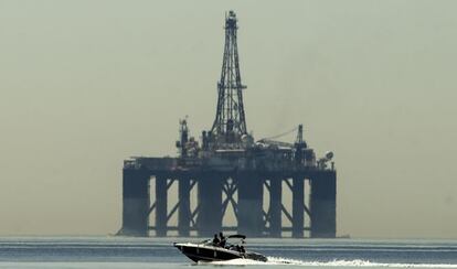 Una lancha pasa frente a una plataforma petrolífera. EFE/Archivo