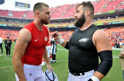 Kansas City Chiefs tight end Travis Kelce, left, talks to his brother, Philadelphia Eagles center Jason Kelce, after they exchanged jerseys following an NFL football game in Kansas City, Mo., Sept. 17, 2017.