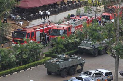 Dos tanquetas y varios veh&iacute;culos de bomberos permanecen aparcados en el exterior del centro comercial Westgate en Nairobi. 