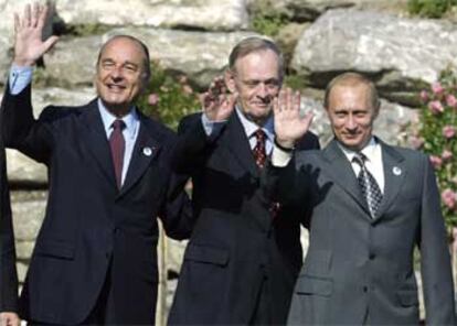 Chirac, acompañado del canadiense Jean Chretien y del ruso Putin saludan a los medios al final de la cumbre.