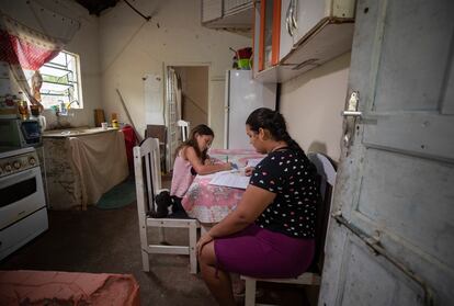 Una mujer ayuda a su hija en sus labores escolares en São Jose dos Campos, en Brasil, en julio pasado.