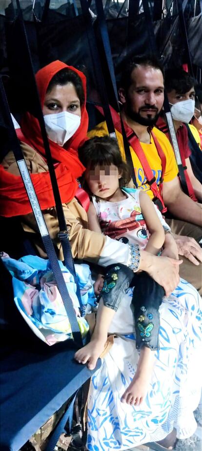 La mayoría de los pasajeros han colaborado con España, han trabajado en la Embajada de Kabul o son familiares. En la imagen, una madre sujeta a su hija en brazos momentos antes del despegue, este viernes en Kabul.