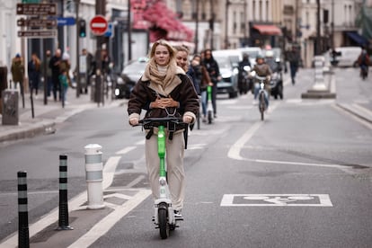 People ride a self-service e-scooter in Paris, France, on April 1, 2023.