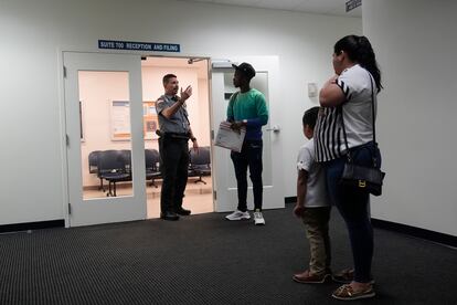 An officer directs people to a courtroom, Wednesday, Jan. 10, 2024,