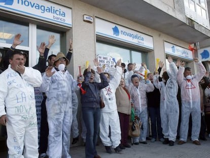 Un grupo de manifestantes protesta ante una sucursal de Novagalicia Banco en A Illa de Arousa.