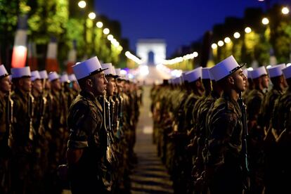 Soldados de la Legión Extranjera marchan por los Campos Elíseos, con el Arco del Triunfo al fondo, en París, durante un ensayo del desfile militar del Día de la Bastilla.