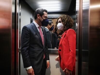 El presidente de la Junta de Andalucía, Juan Manuel Moreno, comparte ascensor con la ministra de Hacienda, María Jesús Montero, en la sede de CC OO en Sevilla.