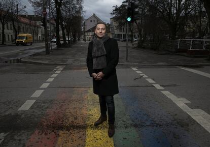 Vladimir Simonko, co-founder of Lithuanian Gay League (LGL), stands above a pride flag painted with the support of volunteers. There are very few visible LGBT+ symbols in Lithuania.