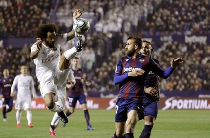 El defensa brasileño del Real Madrid Marcelo Vieira (izda) pelea por el control del balón con el delantero de la UD Levante Borja Mayoral (c) durante el partido correspondiente a la jornada 25 de La Liga disputado en el estadio Ciutat de València.