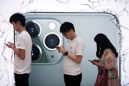 In this file photo taken on September 19, 2019 people queue to try out the new iPhone 11 Pro smartphone at an Apple store in Hong Kong.