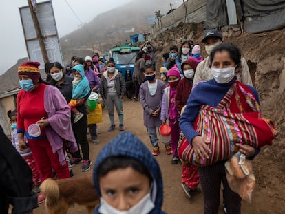 Moradores do bairro de Nueva Esperanza, em Lima (Peru), esperam por um prato de comida em frente a um refeitório comunitário, em 17 de junho de 2020.