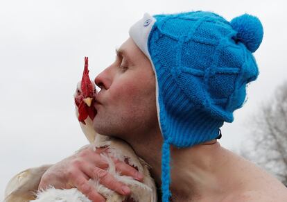 Um homem beija um peru real durante a celebração Maslenitsa em Nikola-Lenivets, na região de Kaluga (Rússia), no dia 17 de fevereiro de 2018