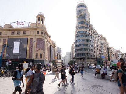 Personas con mascarilla pasean por la madrileña Plaza de Callao.