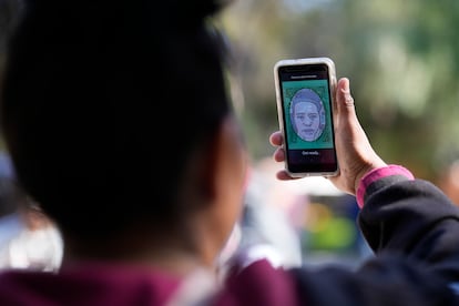 A migrant from Michoacán, Mexico, uses the CBPOne app Tuesday, Jan. 24, 2023, in Tijuana, Mexico.