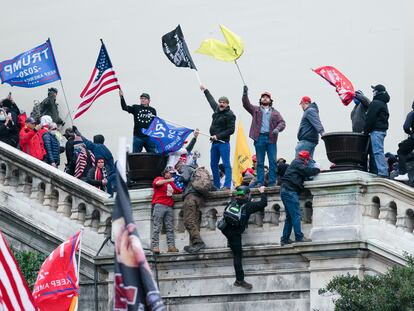 Rioters wave flags on the West Front of the U.S. Capitol in Washington