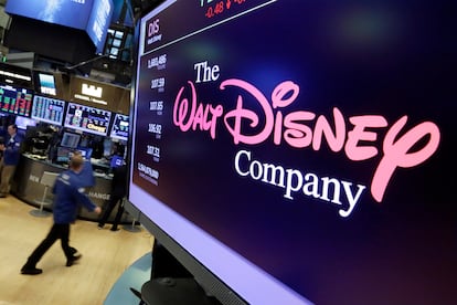 In this Aug. 8, 2017, file photo, The Walt Disney Co. logo appears on a screen above the floor of the New York Stock Exchange.