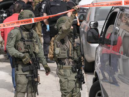 Israeli policemen secure a shooting attack site in east Jerusalem, Saturday, Jan. 28, 2023.