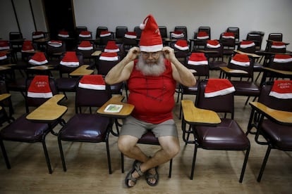 Un estudiante se coloca un gorro de Papá Noel antes de la clase.