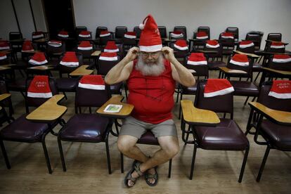 Un estudiante se coloca un gorro de Papá Noel antes de la clase.