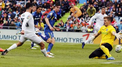 El centrocampista del Real Madrid Isco Alarcón (d) marca el segundo gol del equipo ante el portero del Getafe, Vicente Guaita (c).