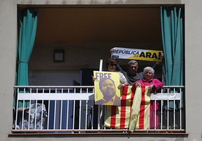 Una mujer sostiene una imagen de Oriol Junqueras desde su balcón durante la manifestación.