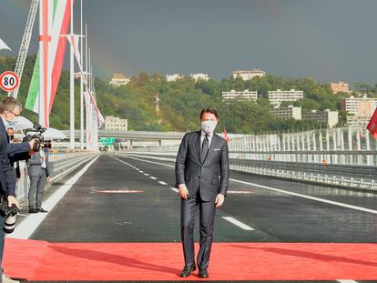 Italian Premier Giuseppe Conte walks along the new San Giorgio Bridge in Genoa, Italy, Monday, Aug. 3, 2020. Two years ago this month, a stretch of roadbed collapsed on Genoa's Morandi Bridge, sending cars and trucks plunging to dry riverbed below and ending 43 lives. On Monday, Italy's president journeys to Genoa for a ceremony to inaugurate a replacement bridge. Designing the new span was Genoa native, Renzo Piano, a renowned architect. (Gian Mattia D'Alberto/LaPresse via AP)