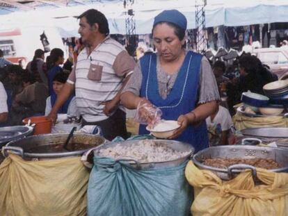 Una boliviana en su puesto, abierto con microcrédito.