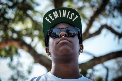 Un chico con una gorra con el lema 'Feminist'.