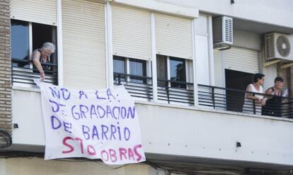 Vecinos de Benicalap cualgan una pancarta contra las obras de Casa Caridad.