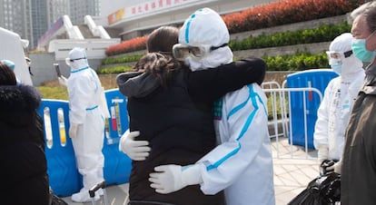 El personal médico abraza a los pacientes dados de alta en el Hospital Wuchang Fangcang, en Wuhan.