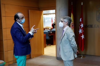 El diputado socialista y presidente de la Comisión de Reconstrucción, Carlos Carnero (d) conversa con el diputado de Vox, José Ignacio Arias (i) durante una jornada de la comisión en la Asamblea de Madrid.